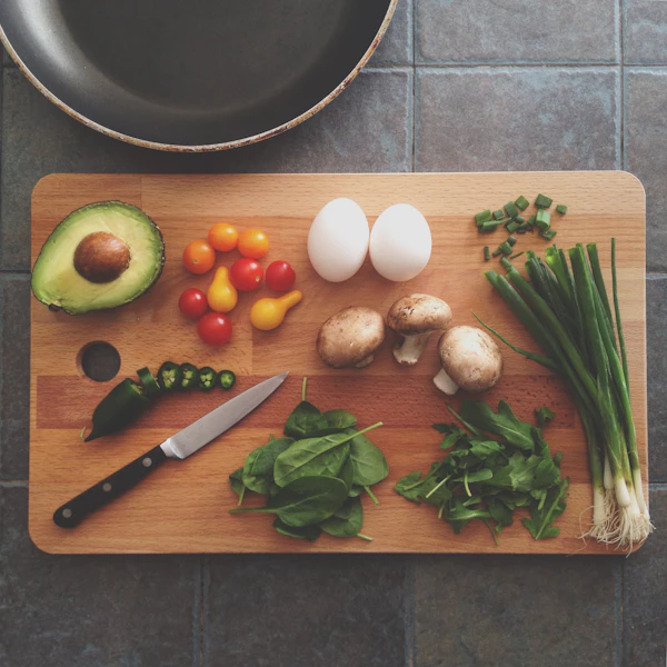 Brunch prep — avocado, eggs and herbs on a board