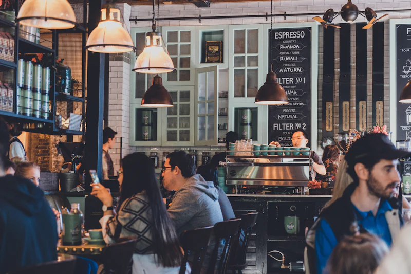 Regulars gathered at the espresso bar under warm pendant lights